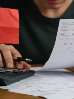 Concerned individual analyzing financial documents, French household debt increase