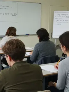Adults learning about the 2026 French Consumer Credit Act in a modern classroom setting.