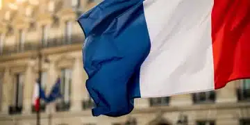 France's 2026 Budget Details: Social Programs & Debt Reduction Focus French flag waving in front of the Ministry of Finance building in Paris, representing the 2026 budget announcement.